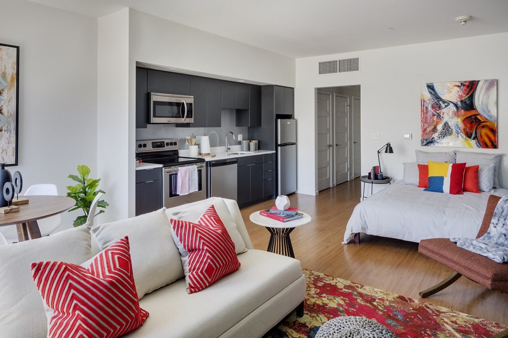 a living room and kitchen with a couch and a table